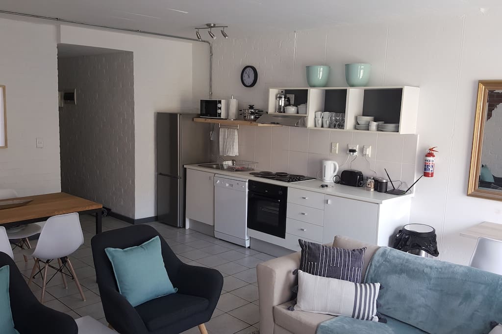 The kitchen is fully equipped with oven, hob, microwave, dishwasher, and a full sized fridge with a freezer.