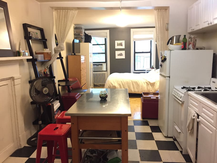 View from kitchen into the bedroom/living area. Kitchen is equipped with everything you might need for enjoying a homecooked meal.