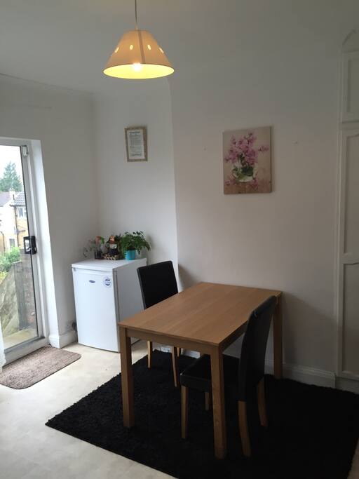 Clean kitchen with table and chairs.