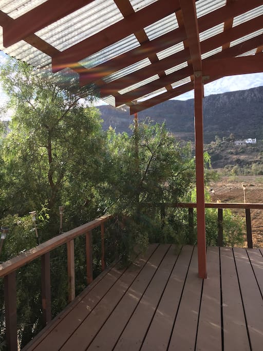 This Not a treehouse it is a large deck surrounded by a railing with a plastic roof. DECK was not an option in picking a description for it