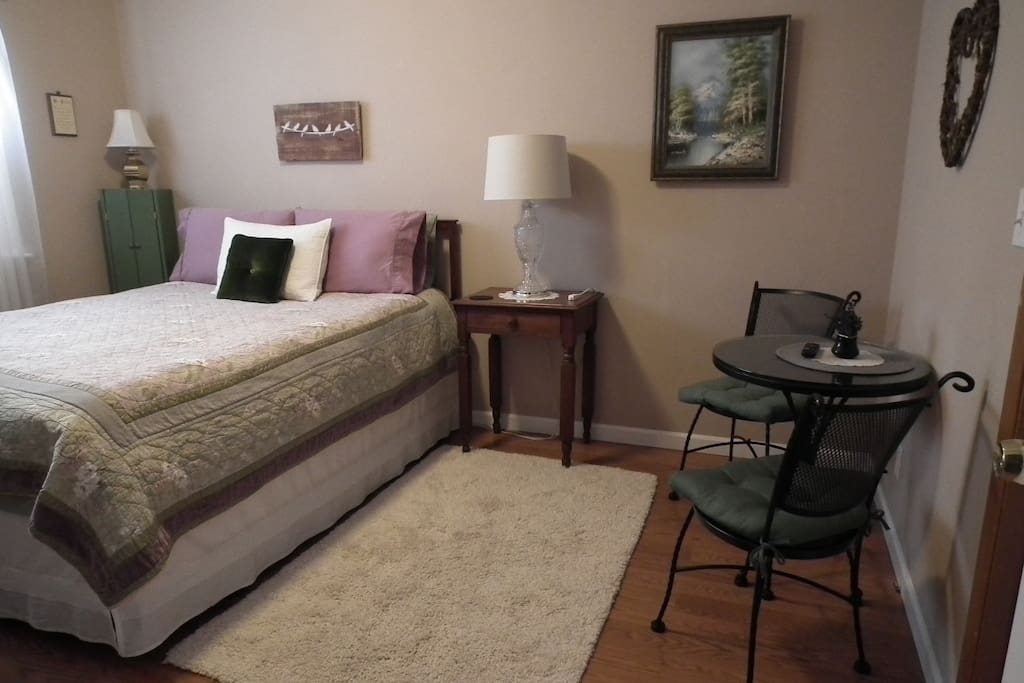 Roomy space with queen memory foam bed, goose down comforter, quilt, wool blankets, sitting area and Roku TV.