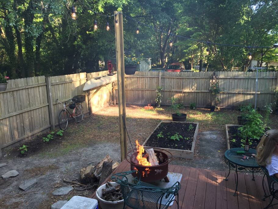 The back deck and yard. Has two fire pits, patio set and grill.