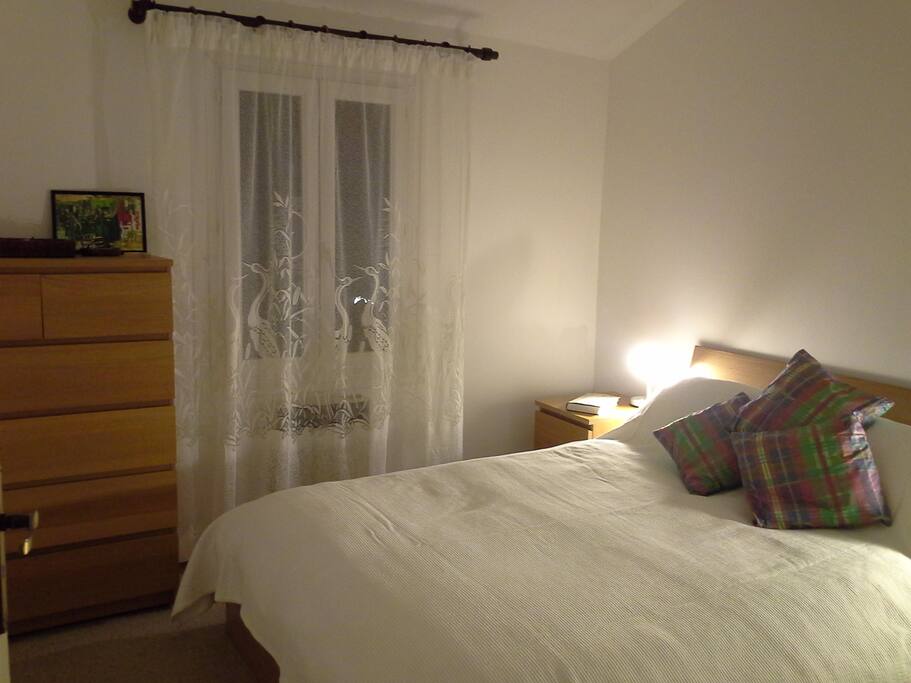 The king-sized bed and bedroom which looks out over the terrace at the back of the house.