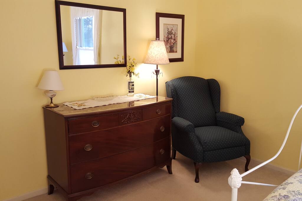 Huge dresser for clothes, comfy chair for reading.