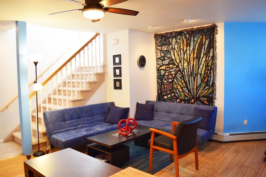 living room w/stairs down from art studio and entrance