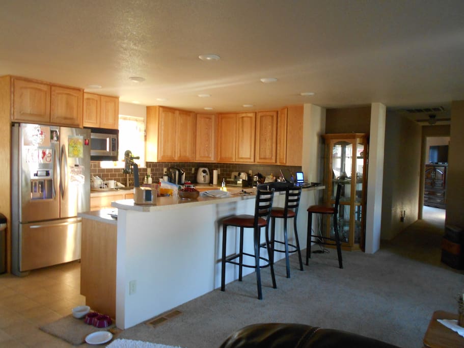 Open kitchen with par sitting and view into living area.