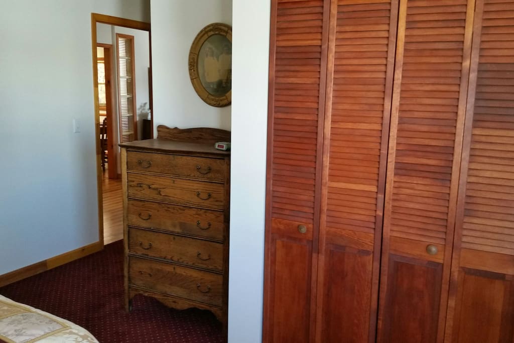 Closet and dresser in bedroom.
