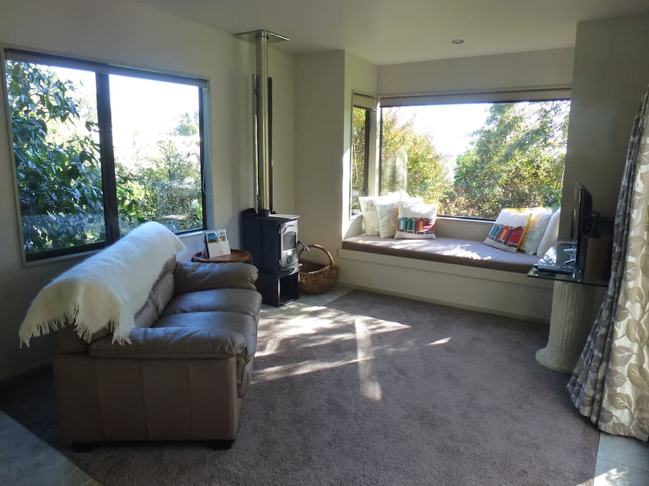 Living room with sunny window seat great to laze on with a good book