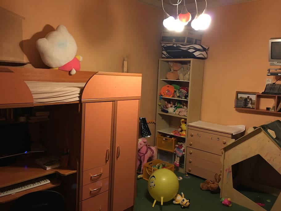 there are plenty of toys and a child's bed in a smaller room. notice - the normal size
sleeping bed is on the upper level