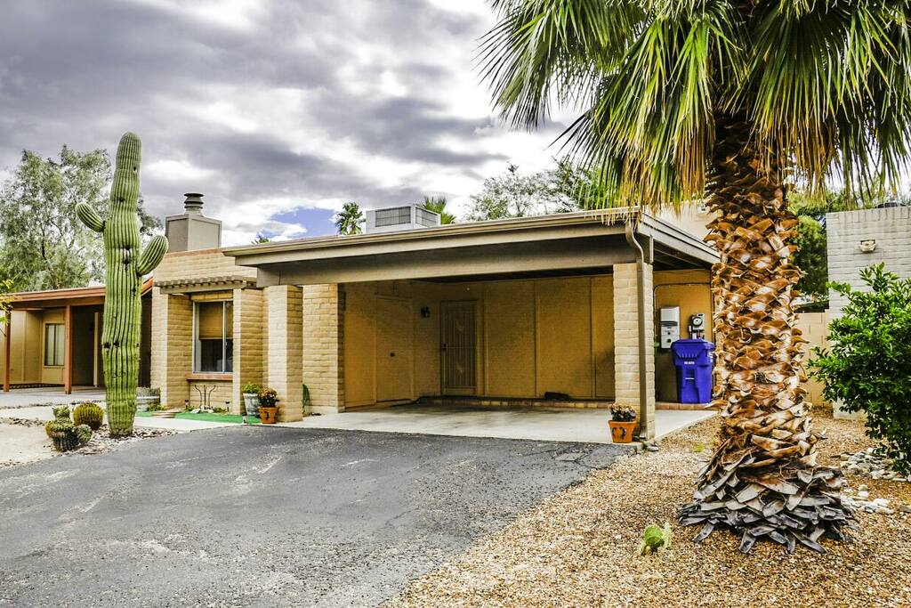Front view with two car parking under car port.