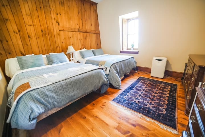 The Little Boy's room has two queen size beds.  The window has a view of the north porch (until we put the air conditioner in front of the window on the window sill.)