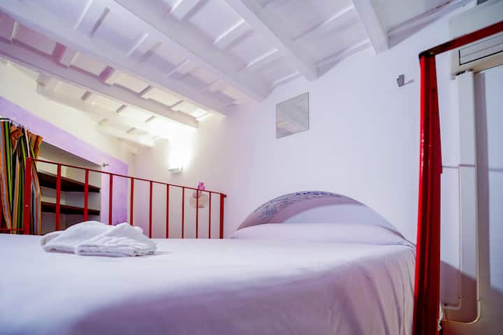 Habitación roja, cama individual y media.