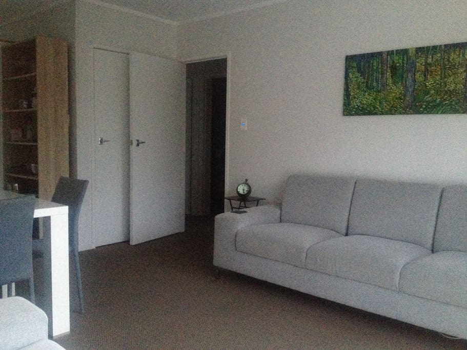 Small hallway access to bathroom and bedroom, kitchen to left and every room in unit is on one ground floor level.