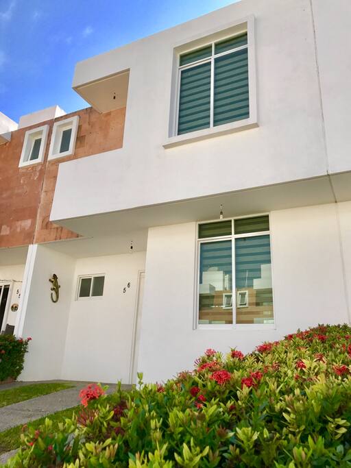 House front with parking spot for two cars