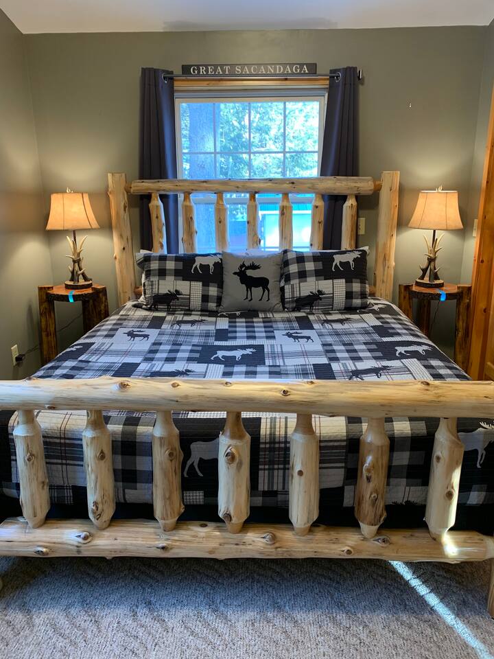 Master bedroom, Lake View Room: king bed, 1 tall dresser, walk in closet with hangers, fan, iron, night stands with antler lamps w/USB cord plug in for chargers