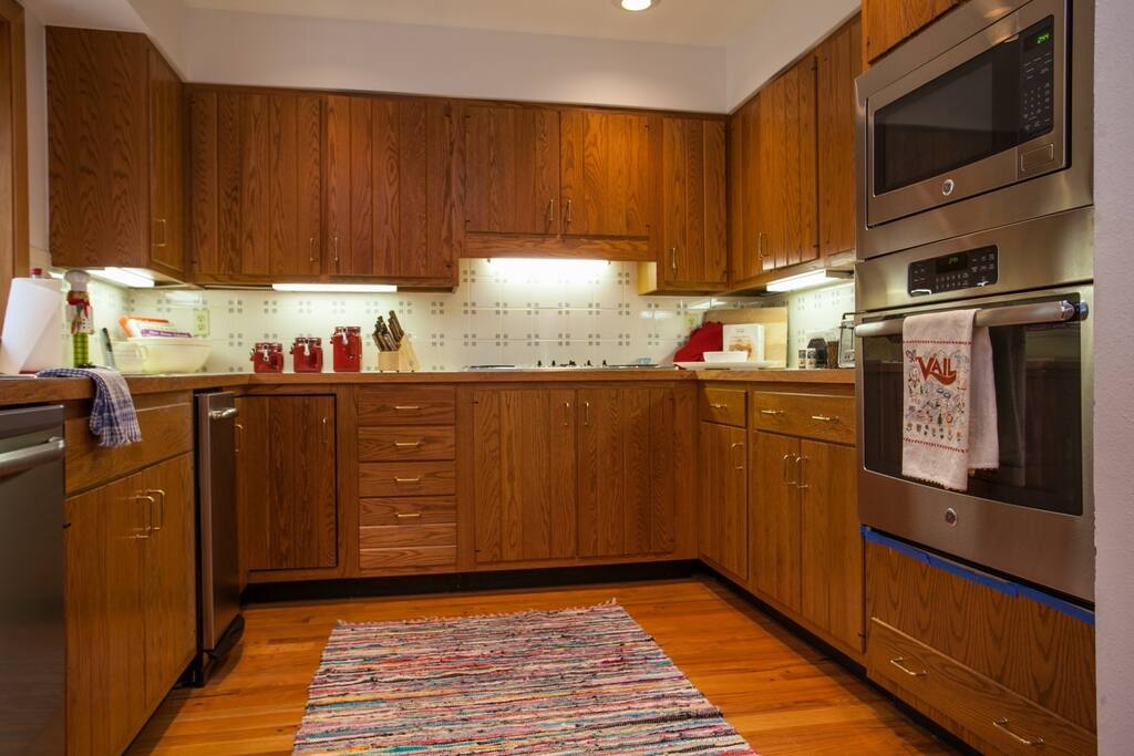 Fully equipped spacious kitchen with stainless appliances.