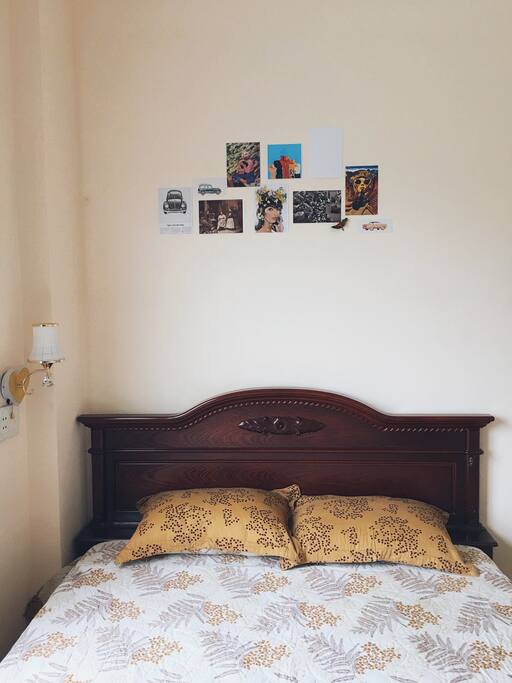 The room is equipped with a bed for two, a wardrobe, a chair and a coffee table