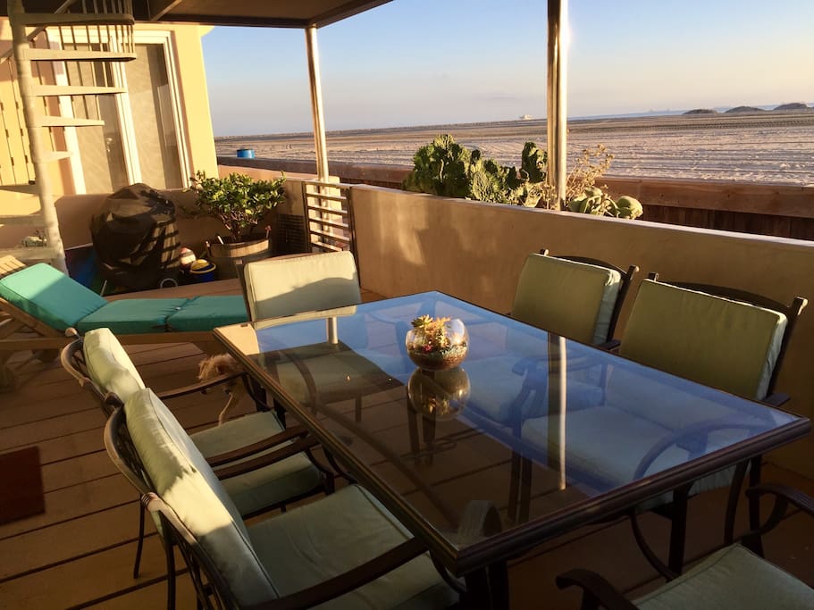 Large covered outdoor deck facing the beach, table with 6 chairs, 1 lounge chair. Charcoal Webber grill, volleyballs, beach chairs, & beach toys provided.