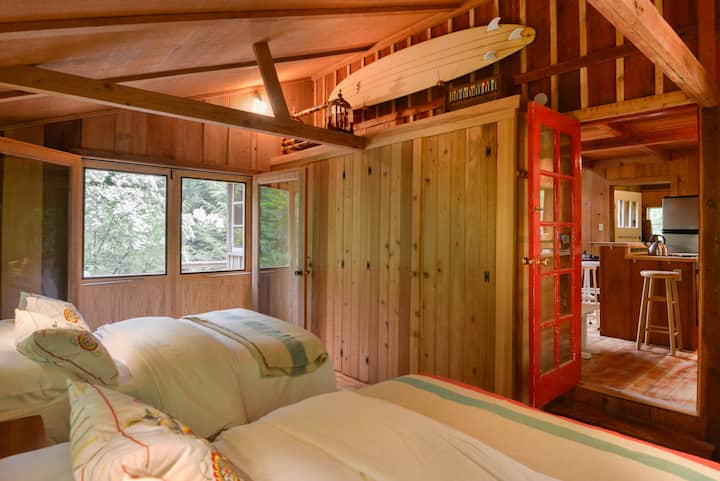 The sleeping porch is just off of the kitchen and opens directly onto a large deck