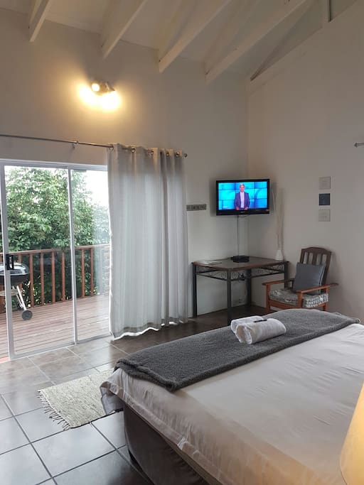 Upstairs via wooden strairs, lovely spacious room with a private balcony and sea few. Full bathroom en-suite.
