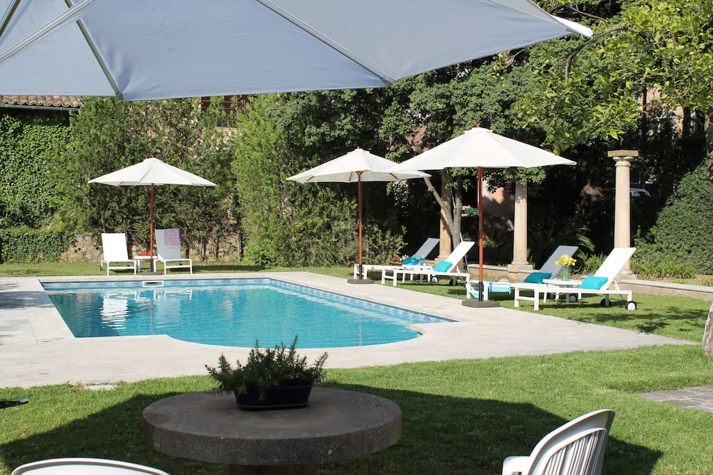 The beautiful pool area offers shade and a number of seating areas to enjoy a refreshing beverage in a serene setting.