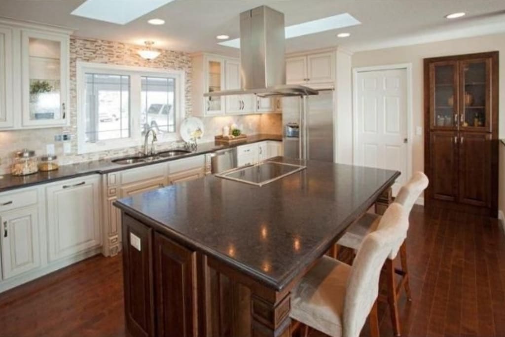 Gourmet kitchen with large granite island.