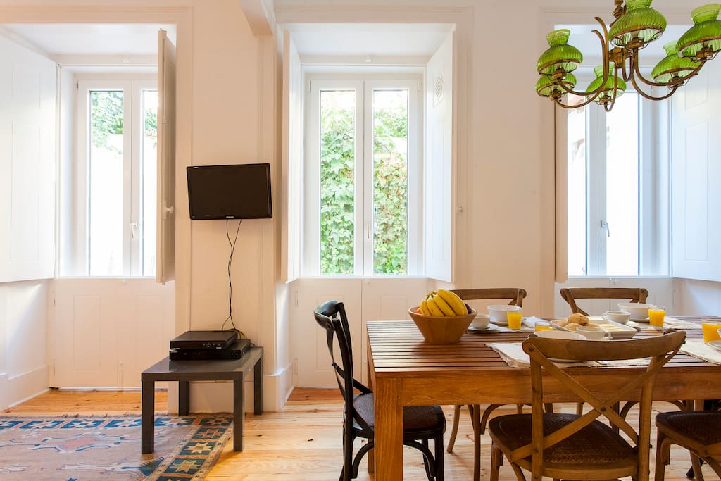 Looking to the 3 beautiful windows that access the patio with half shutters closed!