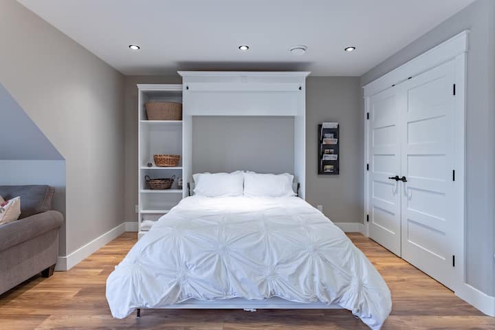 Queen sized wall bed in the living area