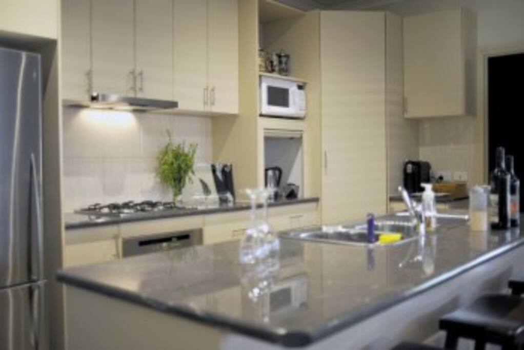 Modern Kitchen with a well stocked pantry and cooking utensils