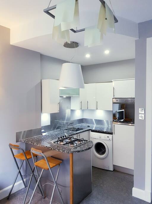 open plan kitchen with granite worktop and washing machine