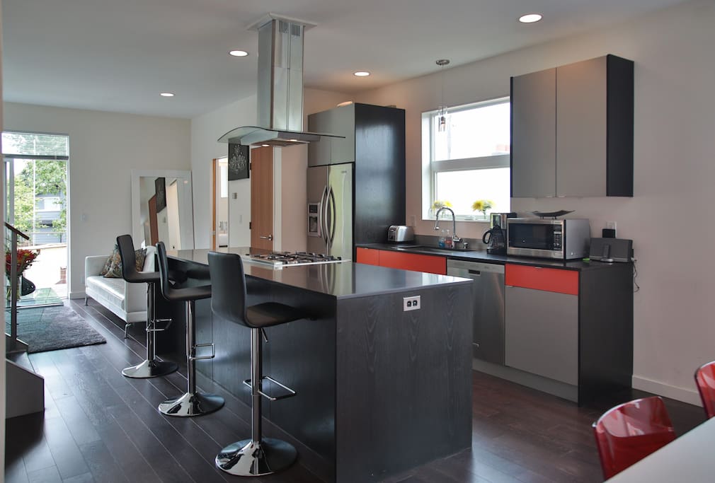 Fully equipped kitchen with full-sized appliances is in the center of great room