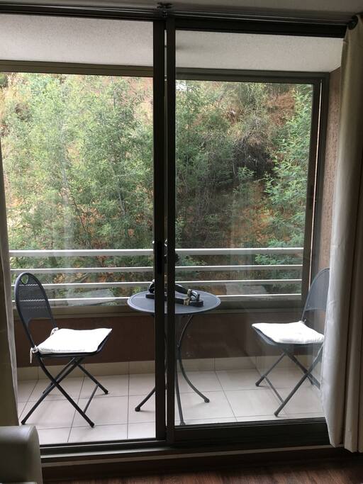 Terraza equipada con dos sillas y mesa