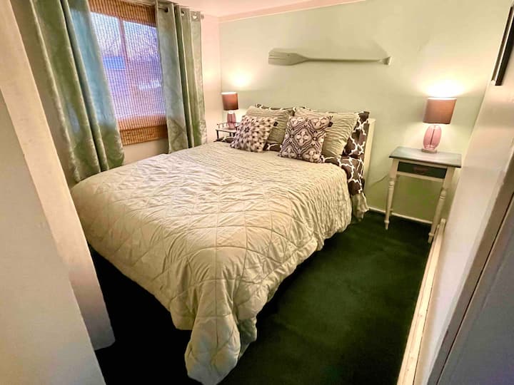 غرفة نوم خارج غرفة المعيشة بإطلالات على سرير كوين والنهر