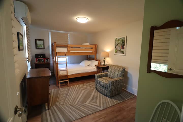 Upstairs bedroom#2 is decorated with all local artists. Twin over full bunk bed. 