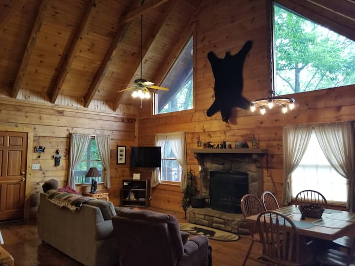 The spacious living area as you enter the cabin will bring a smile to your face.  The faux bear fur on the wall, bright windows, and lovely fireplace will make you feel at home.  