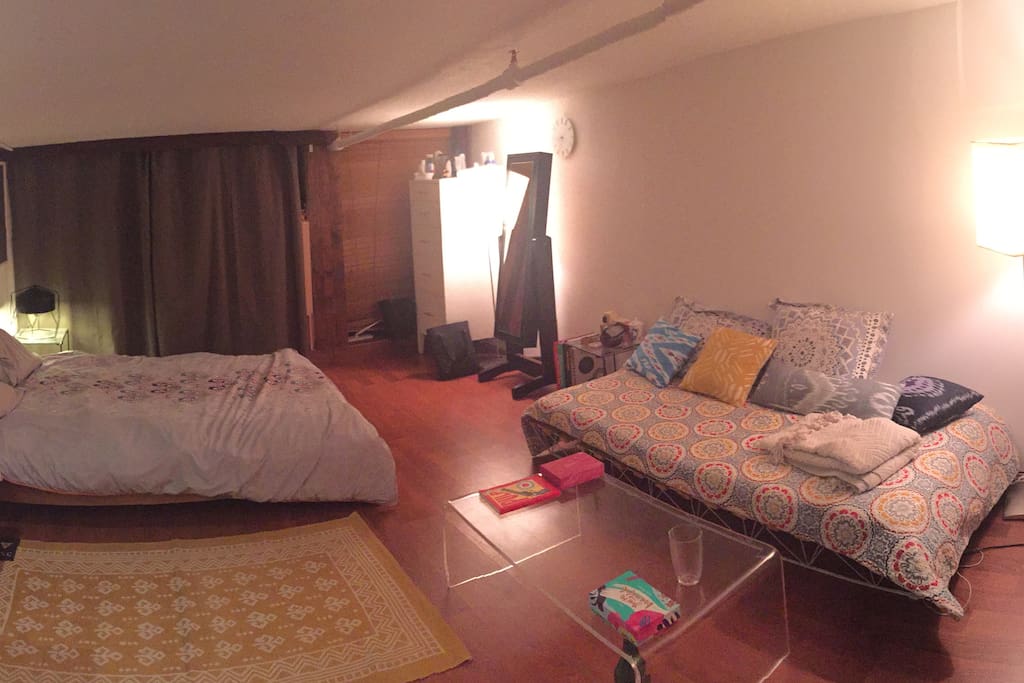 Your room, equipped with a queen-size bed, day bed, and desk.