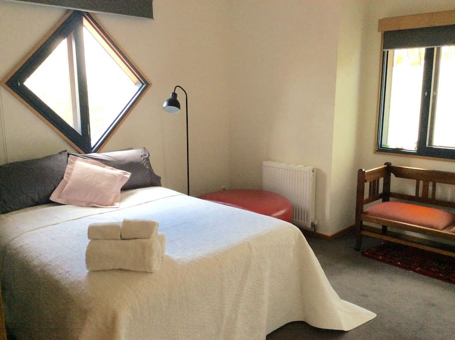 Light filled double bedroom with Burley Griffen inspired diamond window.