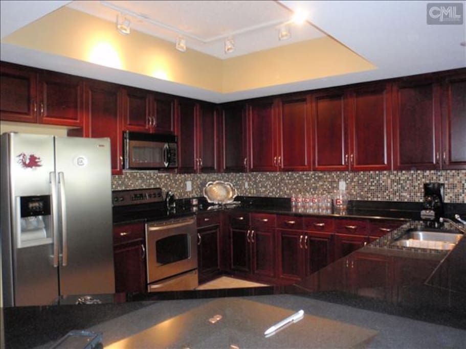 Kitchen area fully equipped. granite counter tops stainless steel appliances