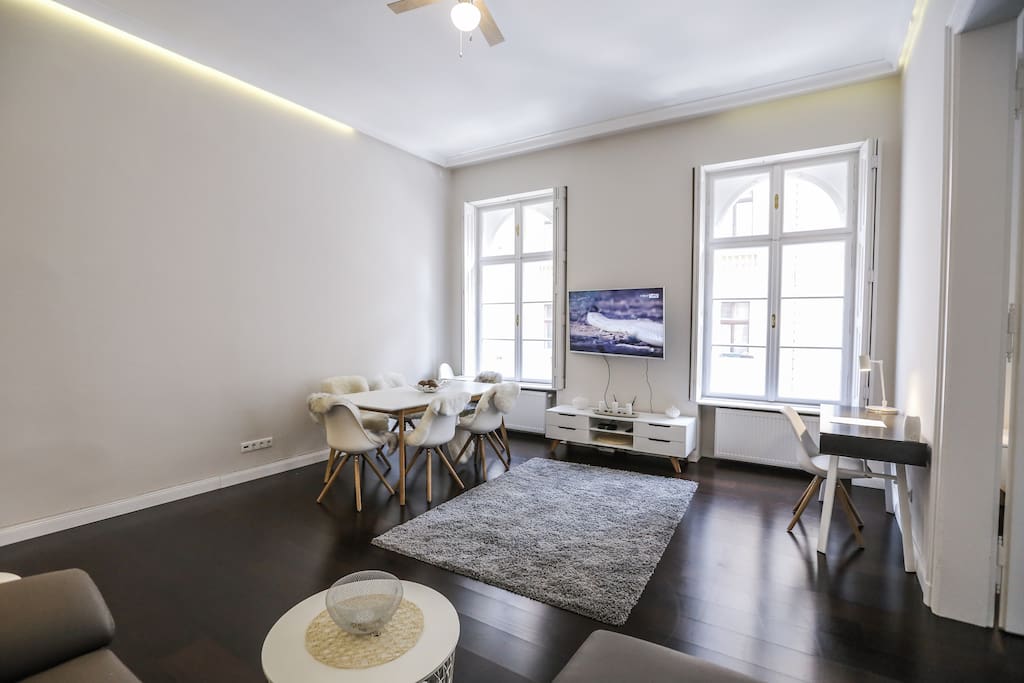 Spacious bright Living room, with large dining table, comfortable couch and big screen TV with local and international channels.