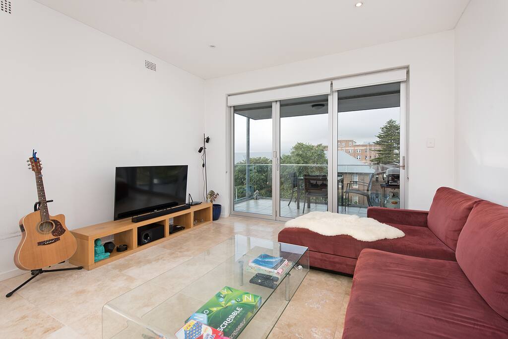 Open plan living area with balcony overlooking Bondi Beach