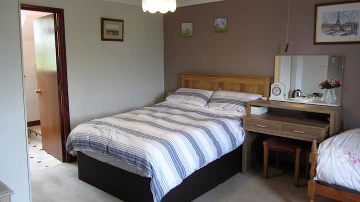 Spacious family or multi person occupancy bedroom. With large double bed and two generous singles.