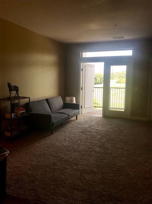 Living room with a comfortable futon for 2 people. You also have access to a balcony with a neat view.