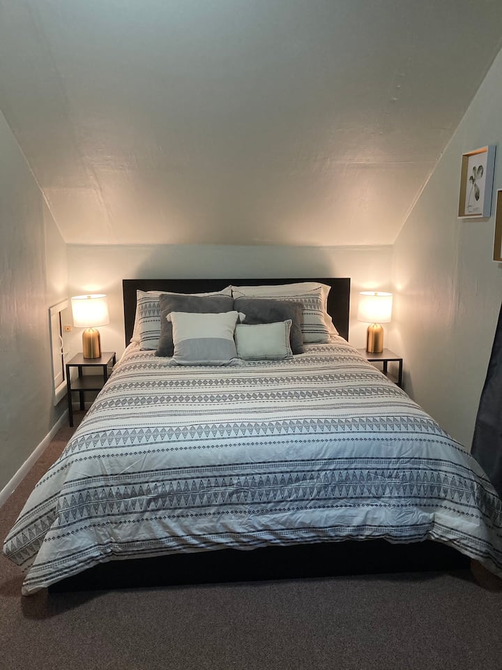 Bedroom located on the second floor next to the office . This bedroom has a TV and also has a portable crib. 