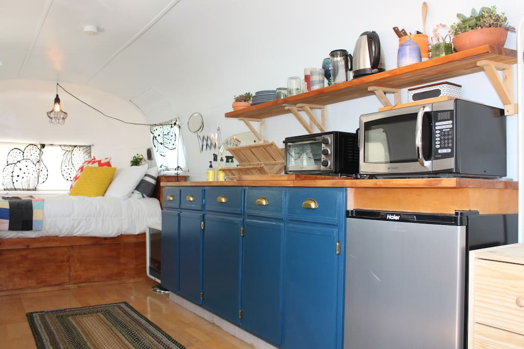 kitchen with microwave, coffee station, toaster oven, fridge, sink, etc