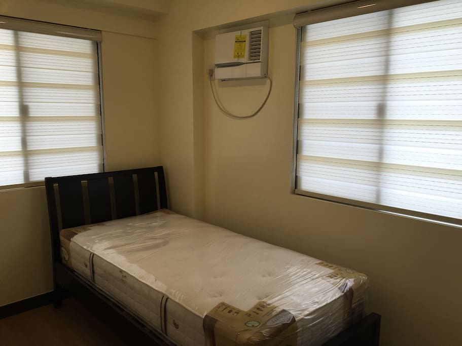 Bedroom 2 with single bed, aircon and closet