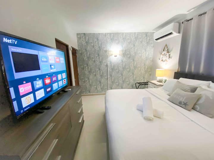Your air-conditioned master bedroom features a king bed, beautiful decor, a TV, ample closet space, an en suite bathroom, and direct access to laundry and a private backyard.