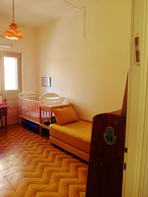 guest room with options for two single beds, plus baby bed