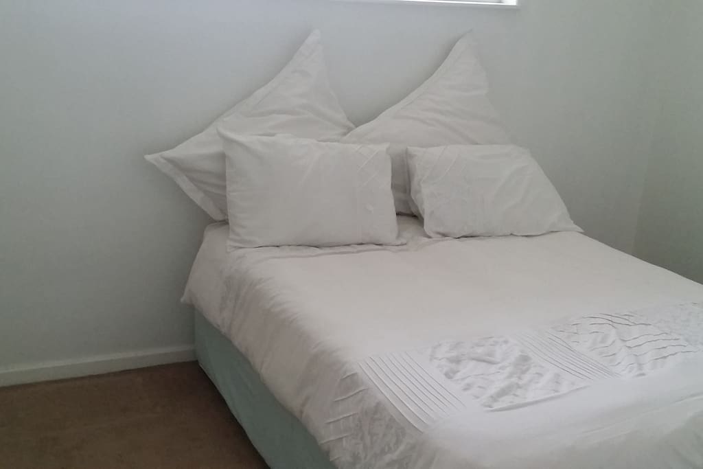 Single room with double bed and cupboards