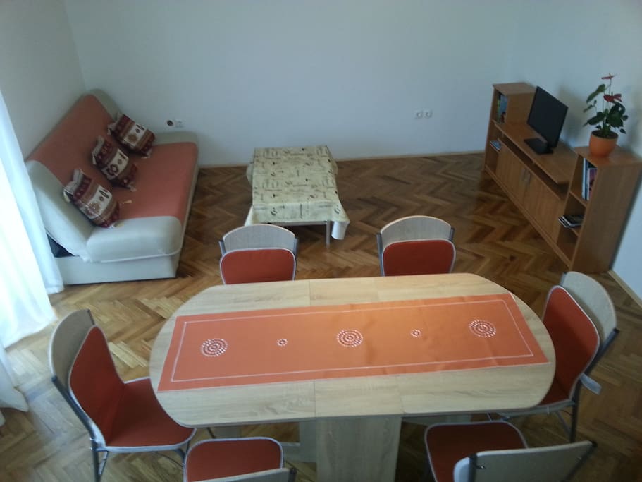 Living room , inside living room is dining table with 6 chairs, TV , Sofa and internal fireplace