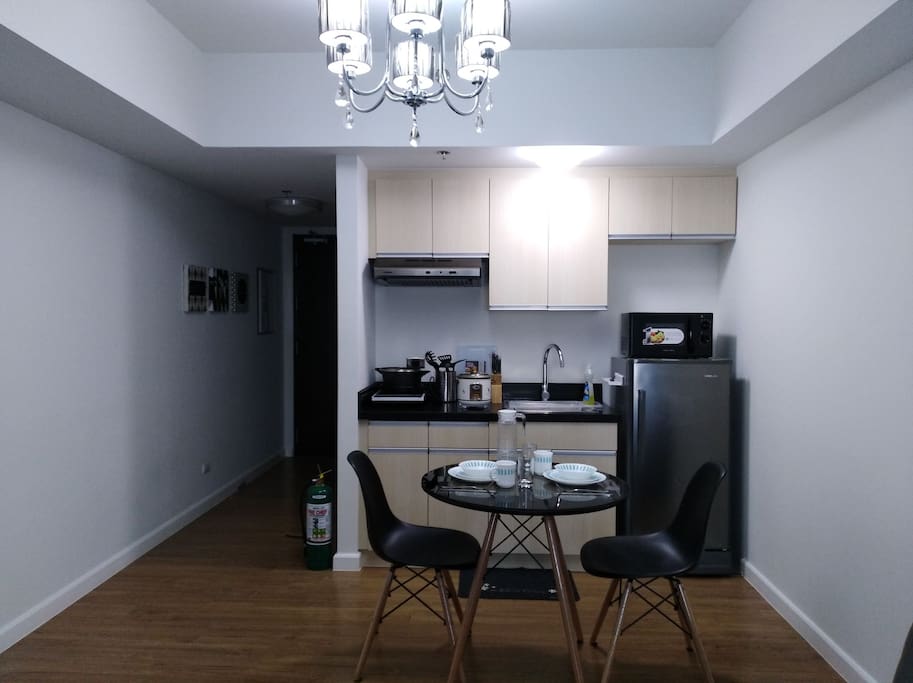 Dinning and kitchen wares are placed in the kitchen cabinets. Only the microwave, water heater, and induction cooker are seen when entering the unit.
